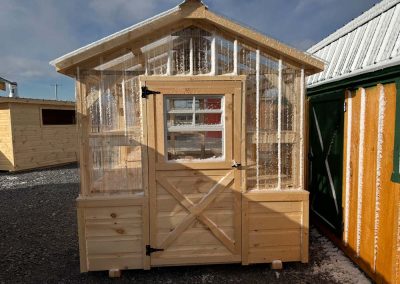 Amish greenhouse with polycarbonate roof and wood frame
