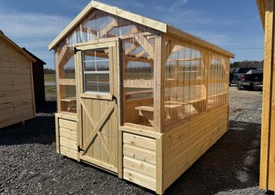 Amish greenhouse exterior with polycarbonate walls and door