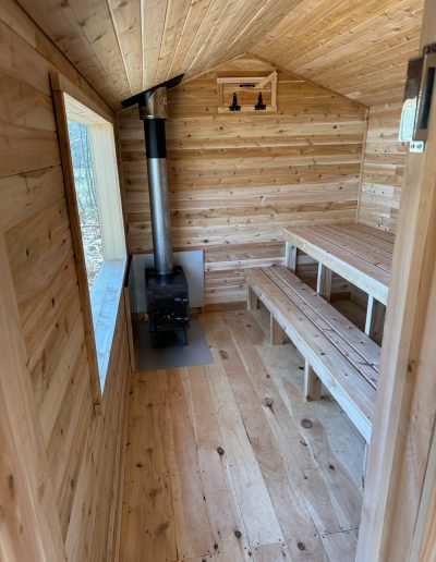 Wood sauna with benches and stove
