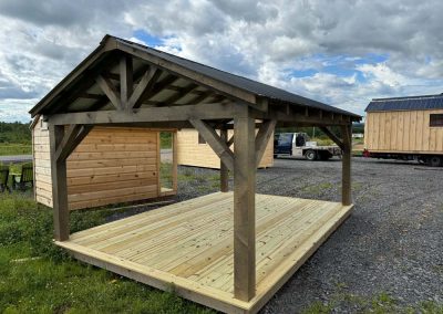Open Amish-built pavilion with black roof on a grass lot