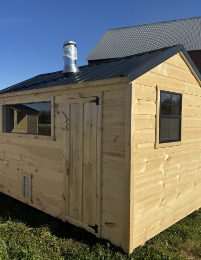 Small Amish built sauna with black metal roof