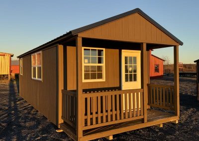 Brown Amish tiny home with covered porch