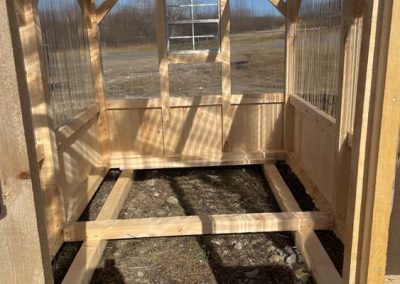Interior view of an Amish greenhouse with polycarbonate roof