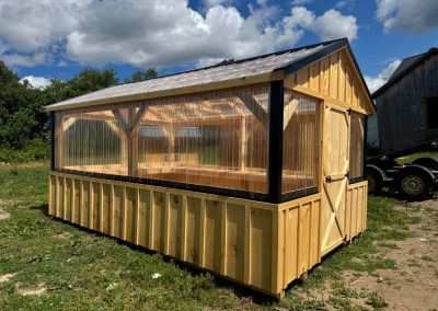 Amish-built greenhouse with wood siding and polycarbonate roof panels