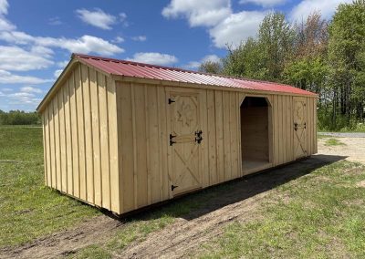 Amish barn with red roof and two stalls