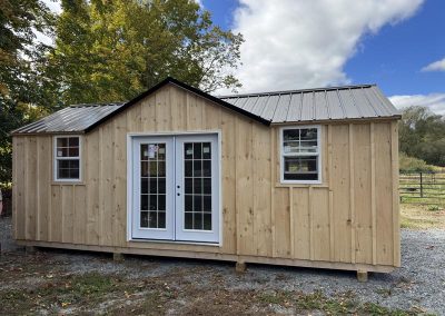 Amish cabin with French doors and tan wood siding