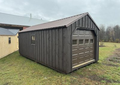 Amish shed with black roof, black door and window