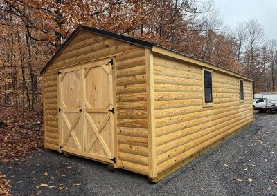 Amish shed with tan wood siding and double barn doors