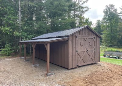 Brown Amish built shed with attached lean to and black roof