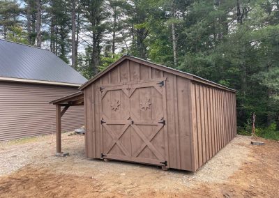 Brown Amish built shed with attached lean to and double doors