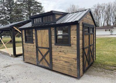 Amish shed with roof cupola vent and covered side porch
