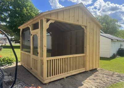 Amish screened pavilion set on a grass lot