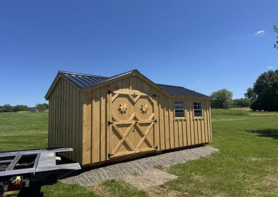 Amish shed with round wheel doors and black roof