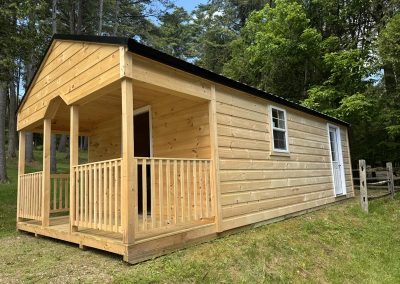 Amish shed with covered porch and wood siding