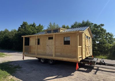 Long Amish cabin on a trailer with wood siding