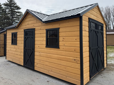 Wood shed with dutch cove siding and black trim