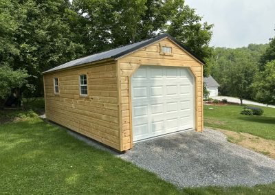 Amish garage with white door and tan siding